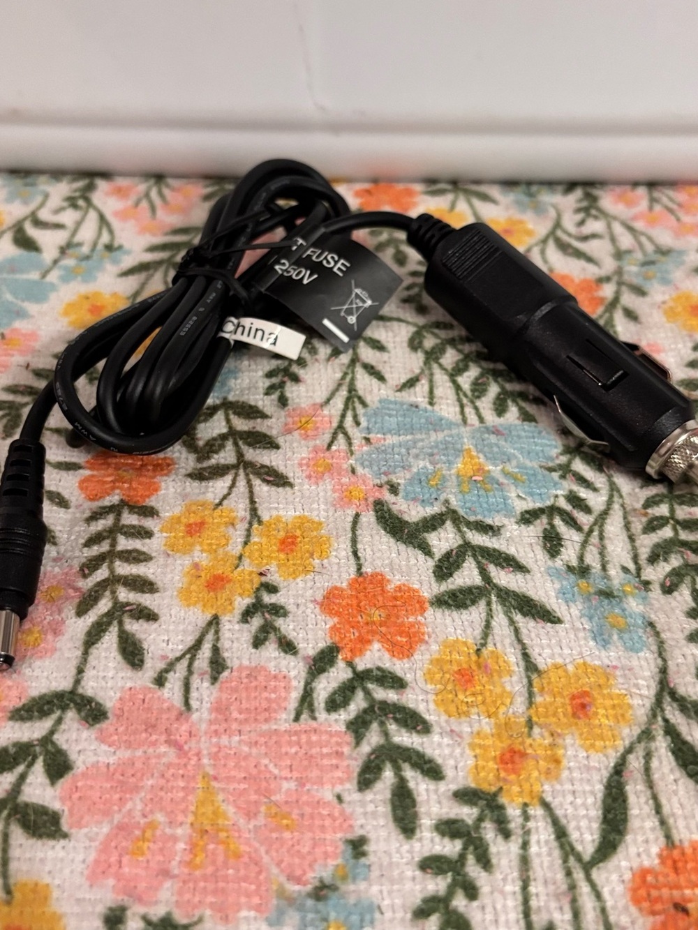 12V DC vehicle power adapter commonly used to charge portable devices